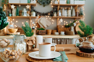 a cup of tea on the table in decorated kitchen for new year. Christmas decor.