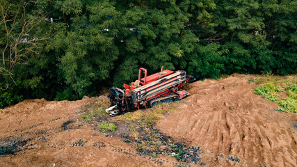 Aerial view of Drilling machine work process. Horizontal directional drilling technology. Trenchless laying of communications, pipes and water pipes. Selective focus - Powered by Adobe