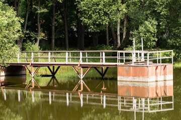 Russia, Vesna, Udelnaya rehabilitation sanatorium, lake with a pier on the shore.