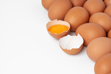 Brown raw eggs and one broken isolated on white background