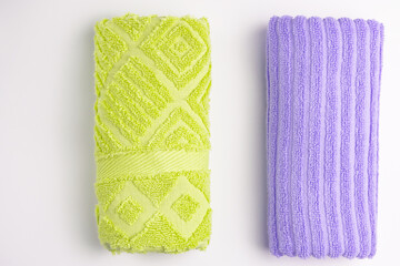 Clean colored towels on a light background. Top view.