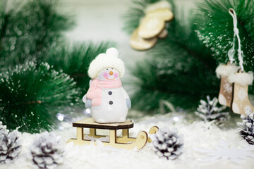 snowman on a sled Christmas decaration, the concept of Christmas and New Year