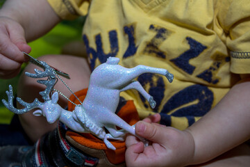Christmas deer in children's hands. Christmas decoration. Close-up. Selective focus