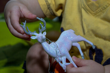 Christmas deer in children's hands. Christmas decoration. Close-up. Selective focus