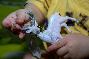 Christmas deer in children's hands. Christmas decoration. Close-up. Selective focus