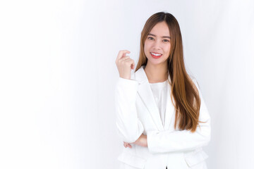 Young Asian beautiful woman who has blond long hair wears white suit and arm crossing while stands with white background. © nut_foto