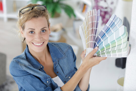 closeup of a beautiful young woman holding color swatches