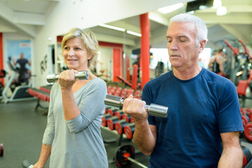 elderly couple doing gym exercises
