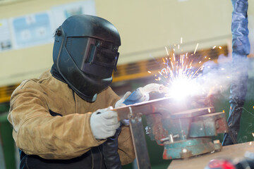 welder working at the factory made metal - obrazy, fototapety, plakaty