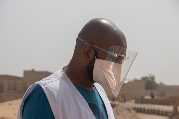 Medical worker using protective transparent mask, combined with medical mask, during pandemic...