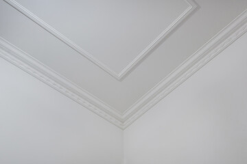 Detail of corner ceiling cornice with intricate crown molding.