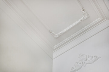 Detail of corner ceiling cornice with intricate crown molding.