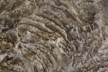 Rough stone surface with hint of warm yellow color. Abstract background for design.