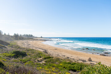 Ocean waves and sandy beach a sunny day. Nature tropical paradise background. Tuross Head, NSW, Australia