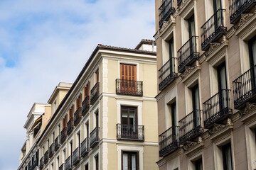 Old residential building against sky. Malasana quarter in Madrid. Real estate and architecture concepts.