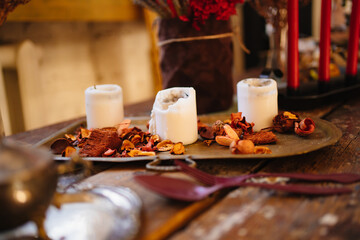 white candles and dried flowers on a tray as a retro style decor 