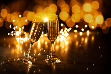 Two glasses of champagne on a background of bokeh lights, 2023 new year