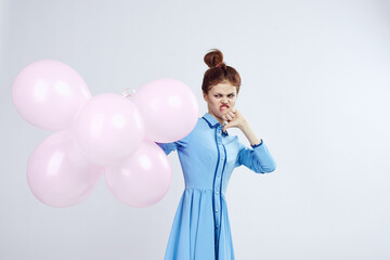 cheerful woman in a blue dress pink balloons holiday birthday