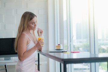 caucasian woman playing tablet in morning