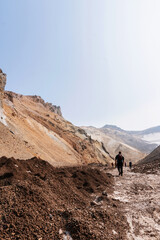 Hike of tourists to the Mutnovsky volcano. Smoking fumarole field. South Kamchatka Natural Park, Kamchatka Territory, Russia