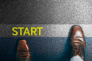 Top view of a businessman in a pair of shoes walking towards the finish line of success.
