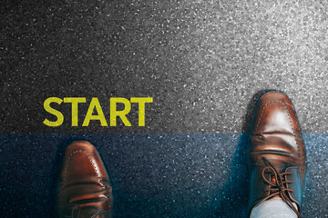 Top view of a businessman in a pair of shoes walking towards the finish line of success.
