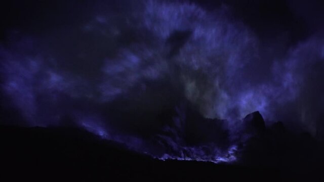 Blue fire of burning sulfur in a crater of a volcano Kawah ijen, Java, Indonesia. Famous tourist attraction, where sulfur is mined. Ijen volcano complex is a group of stratovolcanoes in the Banyuwangi