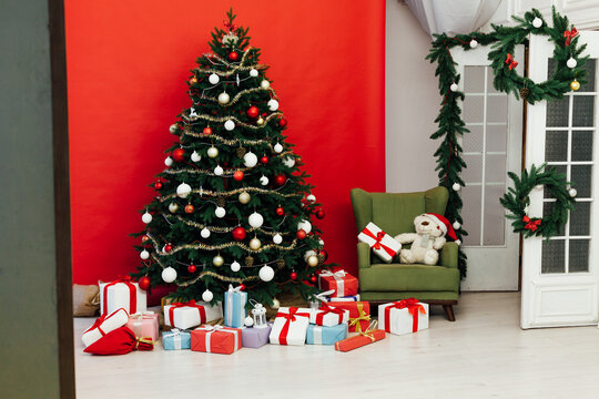 Christmas tree with gifts for the new year red background