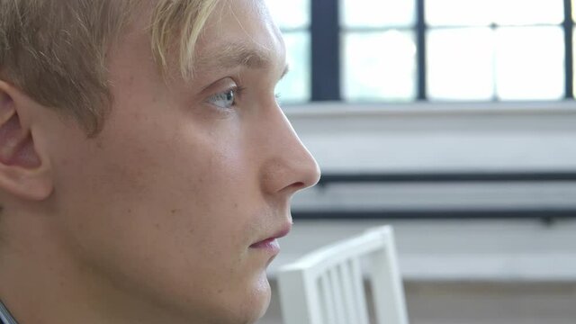 Video of young serene blond man in profile