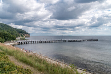 Wooden pier on Baltic Sea in Gdynia Orlowo at cloudy summer day.
