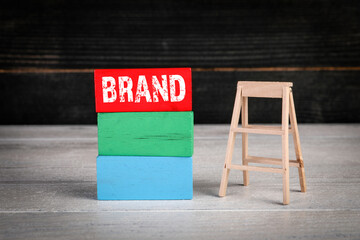 Brand, business development concept. Colored wooden blocks in a pile and stairs