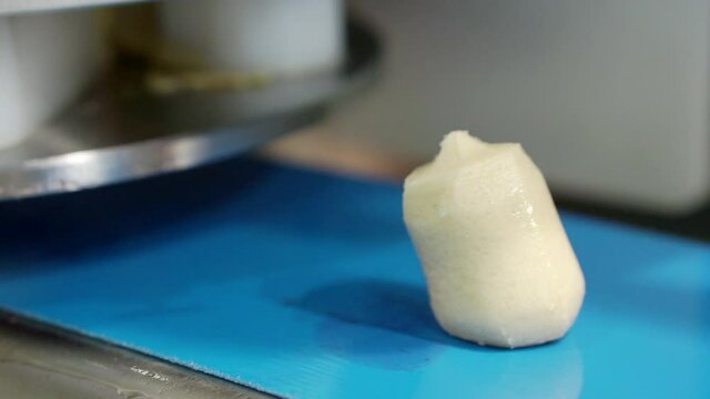 Moving marshmallows along a conveyor line.