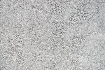The wall of the house, painted vapor-permeable, alkali-resistant, hydrophobic, weather-resistant facade paint by roller. Grey wall painted with roller. 