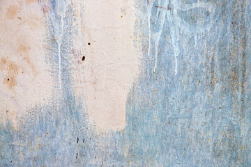 Dirty metal blue wall with traces of white paint and dirty stains with traces of rust background