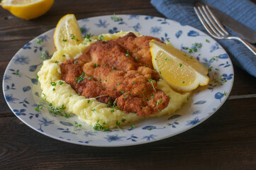 Rustic meal with breaded pork schnitzel and mashed potatoes