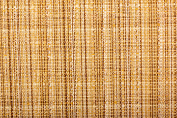 Factory fabric with yellow and red threads interspersed. Close-up long and wide texture of natural red fabric. Fabric texture of natural cotton or linen textile material