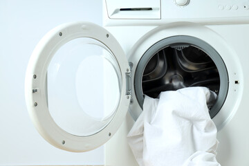 Concept of housework with washing machine on white background
