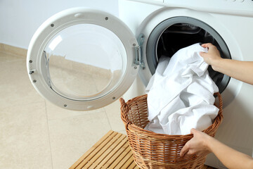 Concept of housework with washing machine against white wall - obrazy, fototapety, plakaty
