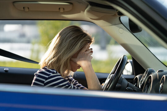 Depressed middle woman driver sitting inside car feeling doubtful confused about difficult decision suffering from personal psychological problem, burnout, quarrel break up with boyfriend, life crisis