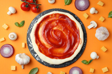 Fototapeta na wymiar Concept of cooking pizza on orange background