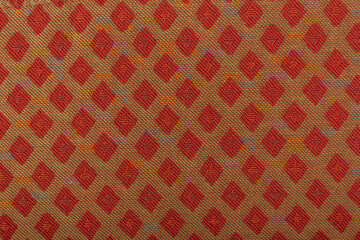 Yellow fabric with red lozenges as the background texture. Close-up long and wide texture of natural red fabric. Fabric texture of natural cotton or linen textile material. Fashion concept design