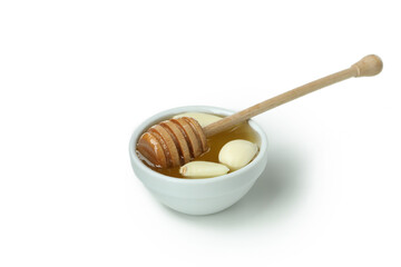Concept of treatment colds with honey and garlic isolated on white background