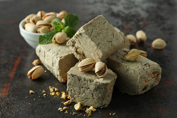 Concept of tasty food with halva on dark textured background