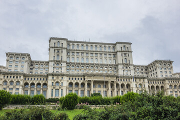 Fototapeta na wymiar Palace of the Parliament (Palatul Parlamentului) building in Socialist realist Neoclassical architectural forms. Palace reaches a height of 84 meters. Bucharest, capital city of Romania.
