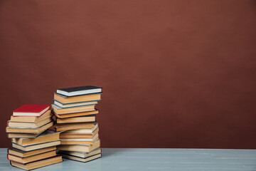 stacks of educational books in the library on a brown background