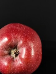 Closeup beautiful red delicious apple with copy space and selective focus on black background