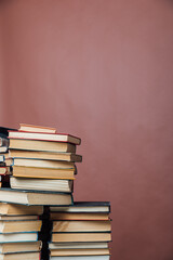 stacks of educational books in the library on a brown background