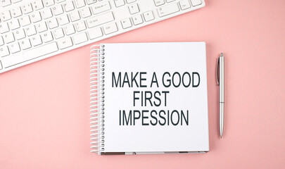 Pink office desk with keyboard and notebook , text MAKE A GOOD FIRST IMPRESSION