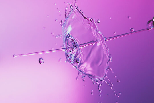 Water Splash On A Purple Color