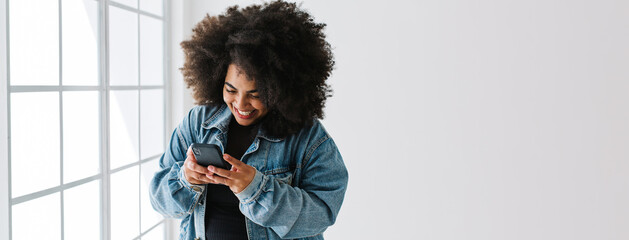 Attractive woman texting on mobile phone - Powered by Adobe